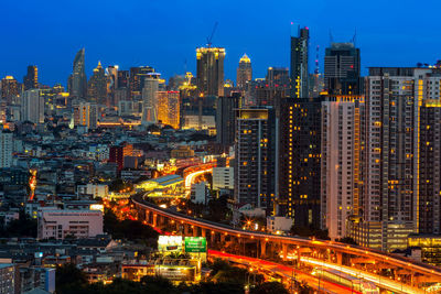 Illuminated cityscape against sky at night