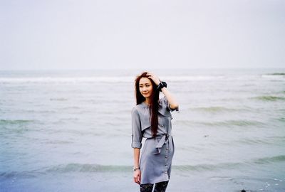 Rear view of woman standing on beach