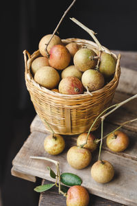 High angle view of longans in wicker basket on table