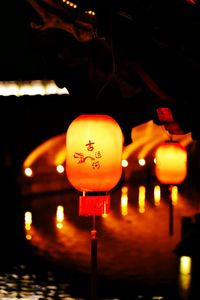 Illuminated lanterns hanging at night