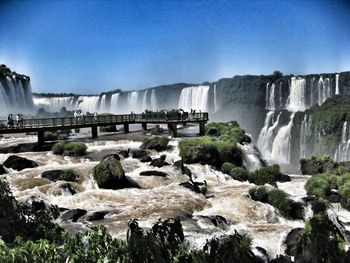 Scenic view of waterfall against sky