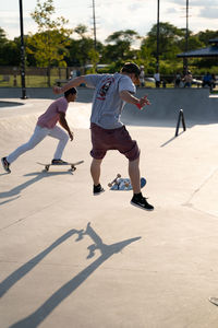 Rear view of man skateboarding on skateboard