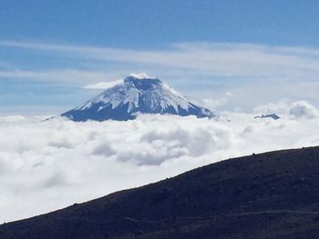 Scenic view of snowcapped mountain against cloudy sky