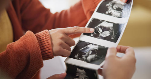 Midsection of woman using mobile phone