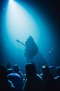 Silhouette woman performing on stage