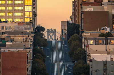 Buildings in city against sky during sunset