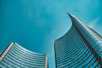 Low angle view of modern building against blue sky