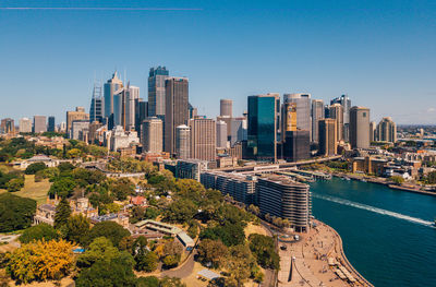 Aerial view of buildings in city against clear sky