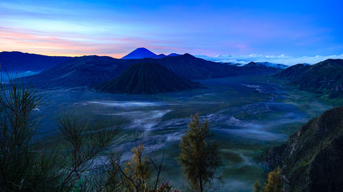 Panoramic view of volcanic landscape against sky during sunset