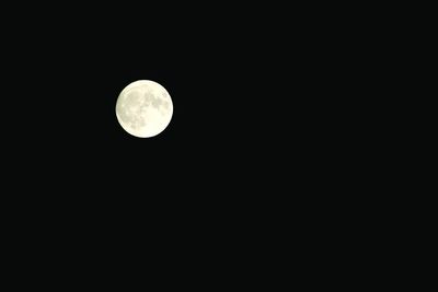 Low angle view of moon against clear sky at night