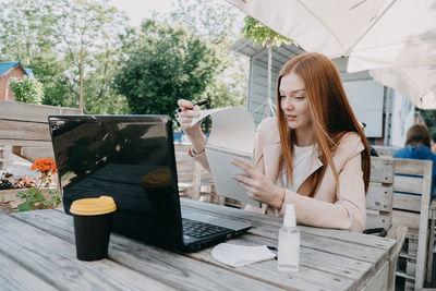 Working safely in new normal. how to make a covid secure workplace. redhead business woman hair