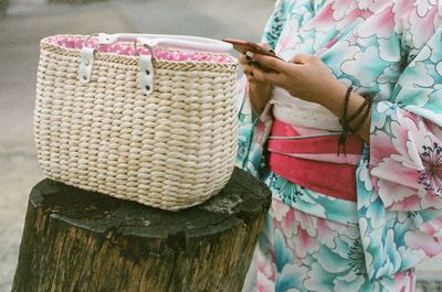 Midsection of woman using phone