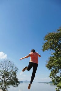Low angle view of woman jumping
