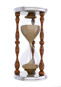 Close-up of clock on table against white background