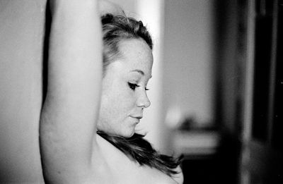 Close-up side view of shirtless seductive woman