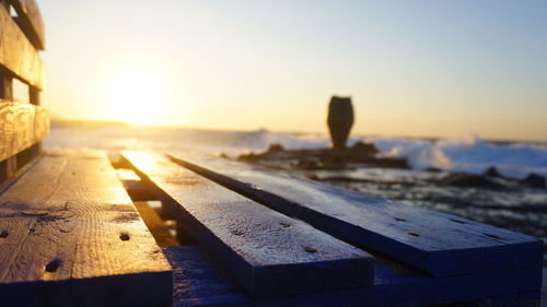 Close-up of wood against sky during sunset