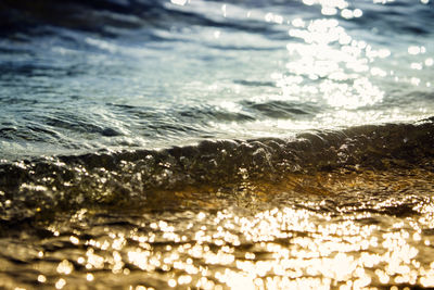 Close-up of sea against sky during sunset