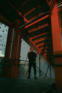 Rear view of man walking in building