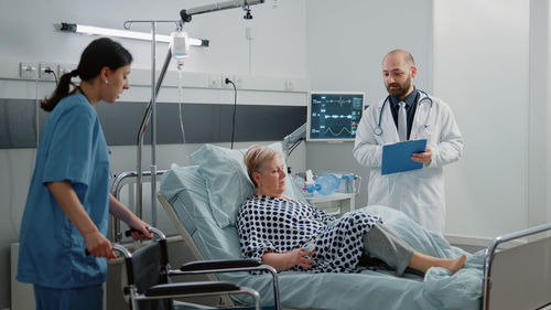 Female doctor examining patient in hospital