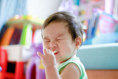 The cute asian boy toddler is eating snack. portrait cute asian baby with blurred background. 