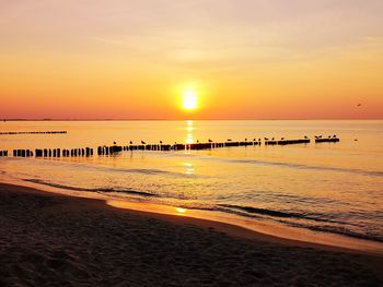 Scenic view of beach against sky during sunset