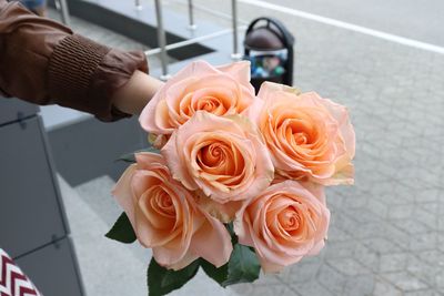 Close-up of hand holding rose bouquet