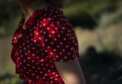 Midsection of woman wearing red polka dot dress