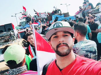 Portrait of young man with flags in traditional clothing