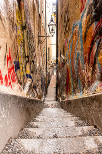 Footpath amidst buildings in city