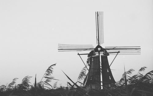 Low angle view of traditional windmill against clear sky