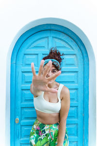 Carefree woman on tropical holidays reaching hand. woman on the beach on spanish travel destination.