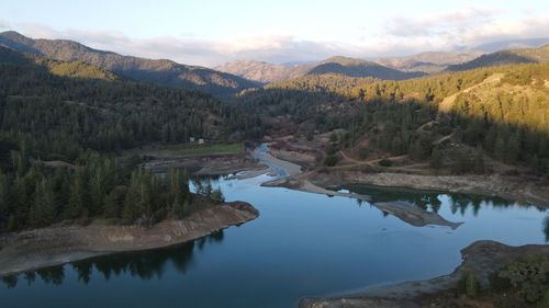 Scenic view of lake and mountains against sky