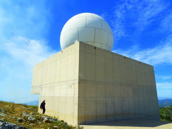 Woman standing by meteorological radar at tivissa