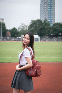 Portrait of smiling young woman standing outdoors