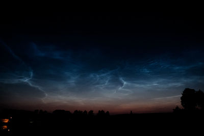 Low angle view of silhouette trees against sky at night