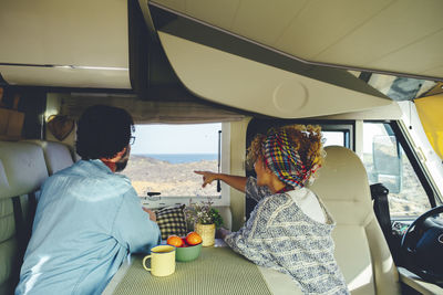 Rear view of woman sitting in car