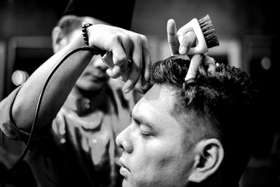 Hairdresser with customer in saloon