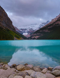 Scenic view of lake and mountains against sky