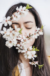 Close-up of woman with pink flowers