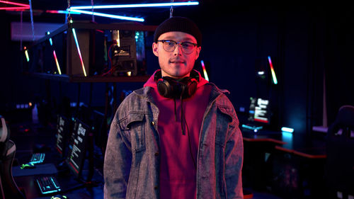 Portrait of young man standing at night