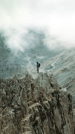 Rear view of man walking on mountain