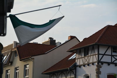 Low angle view of flag against buildings