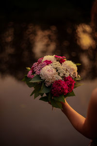 Close-up of hand holding bouquet of flower