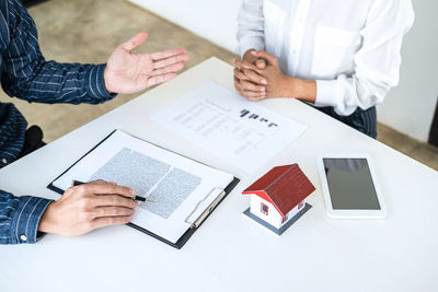 High angle view of man talking with real estate agent