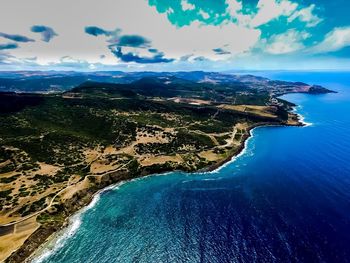 Aerial view of sea against cloudy sky