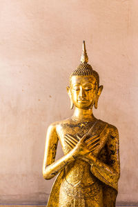 Statue of buddha against wall