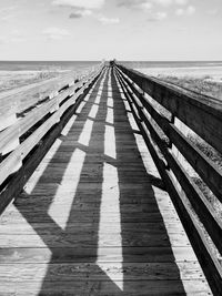 Shadow of railing on beach