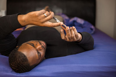 Low section of woman holding dog at home