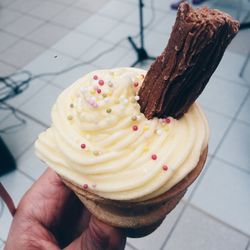 Cropped hand of woman holding ice cream