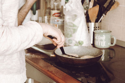 Midsection of man preparing food in kitchen